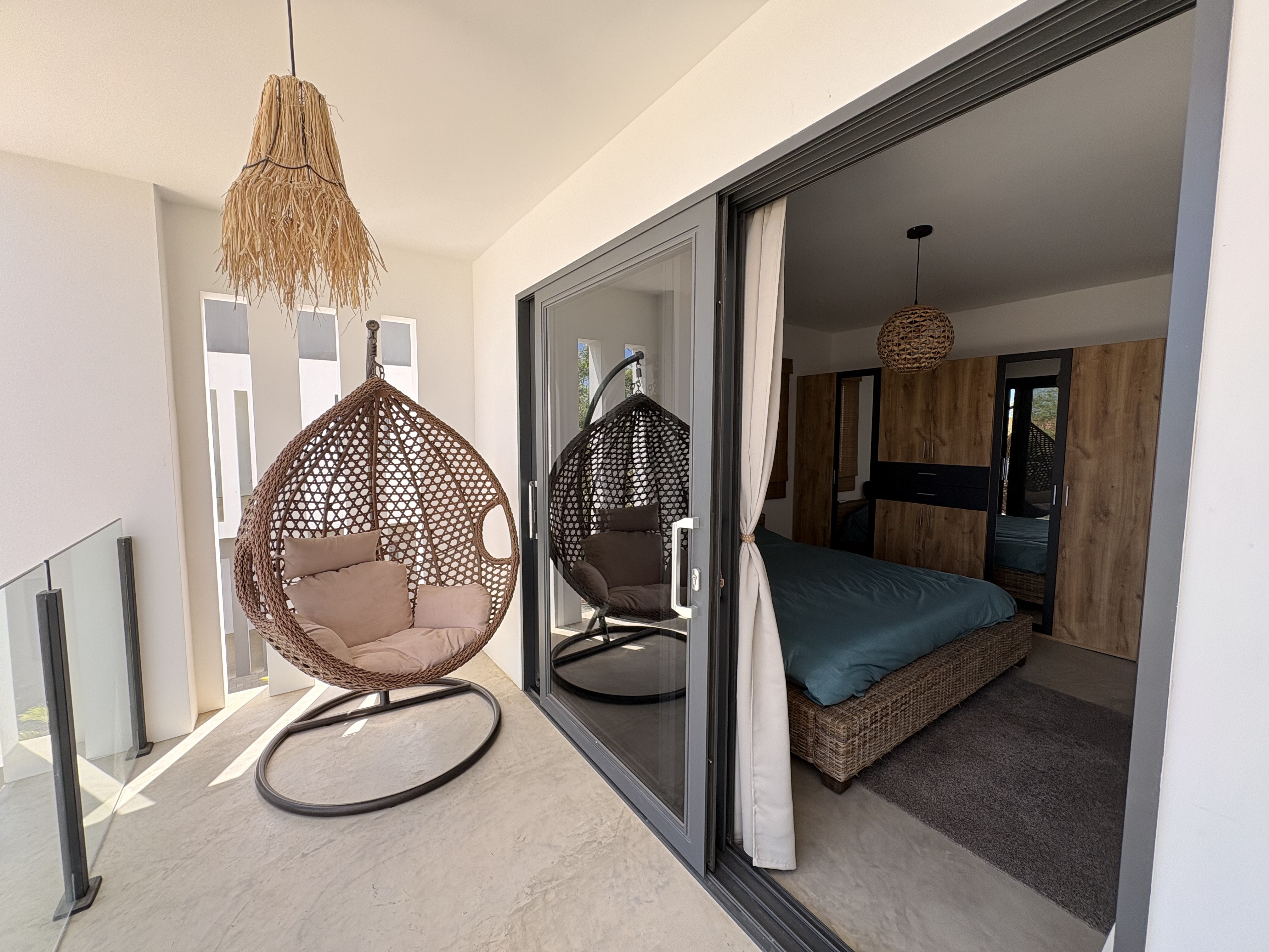 Master bedroom balcony with hanging chair